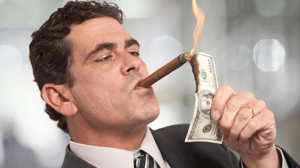 Rich-Businessman-Lighting-Cigar-With-100-Dollar-Bill